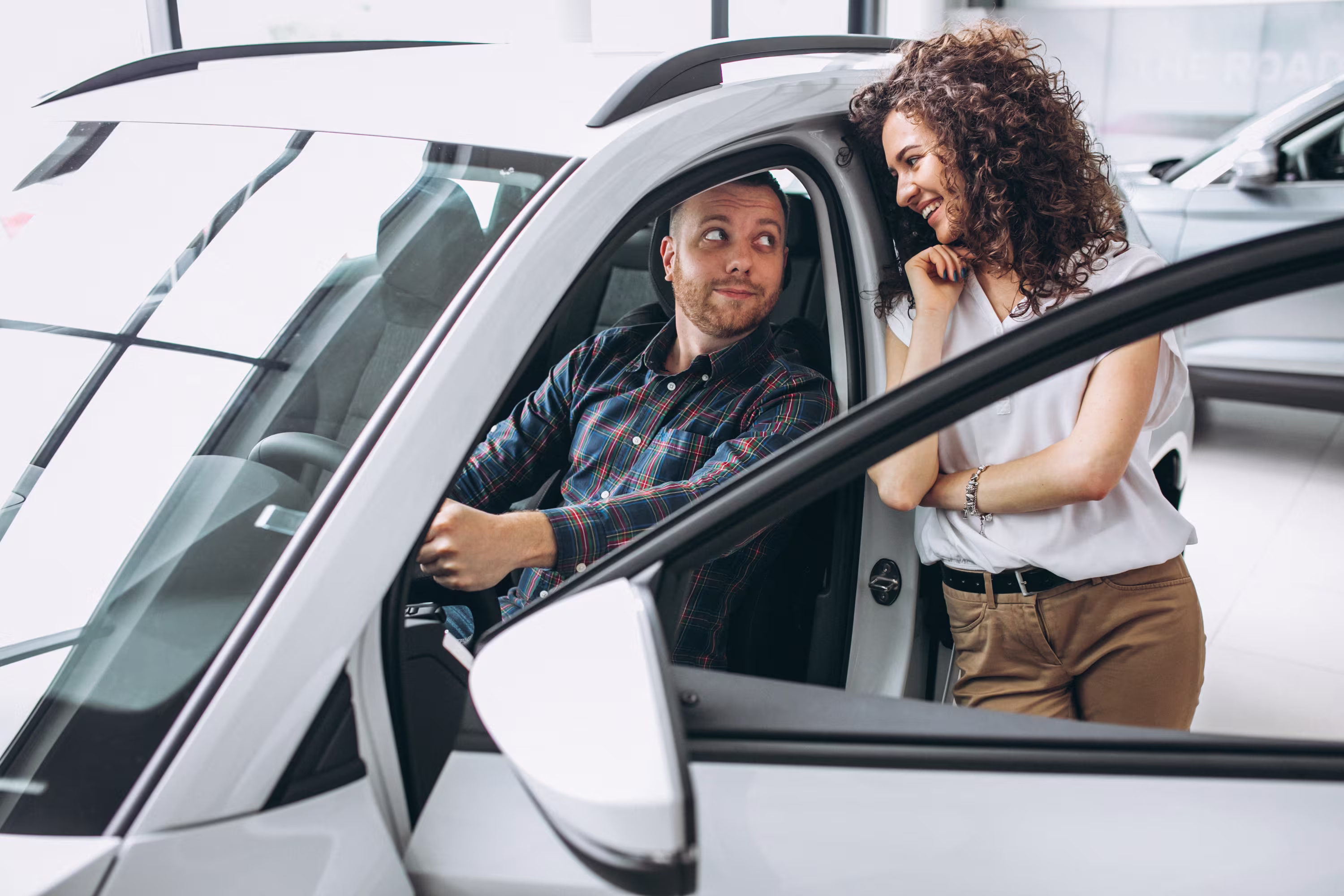 Family standing next to their new car